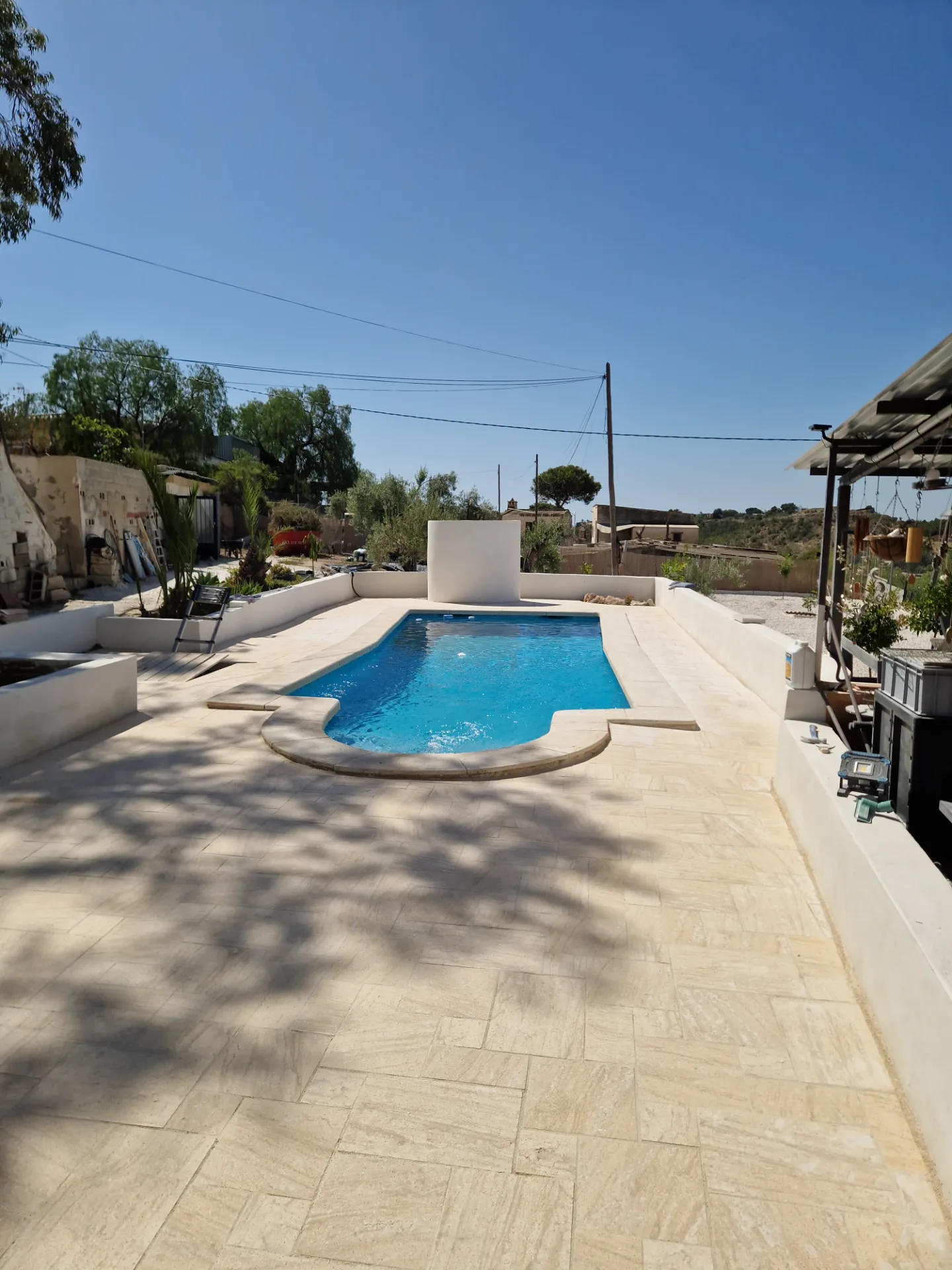 After: Pool & terrace — travertine instead of concrete — carried out by Handwerker Costa Blanca
